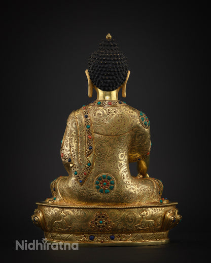 Back view of Shakyamuni Buddha statue showing lotus throne and deer motif base
