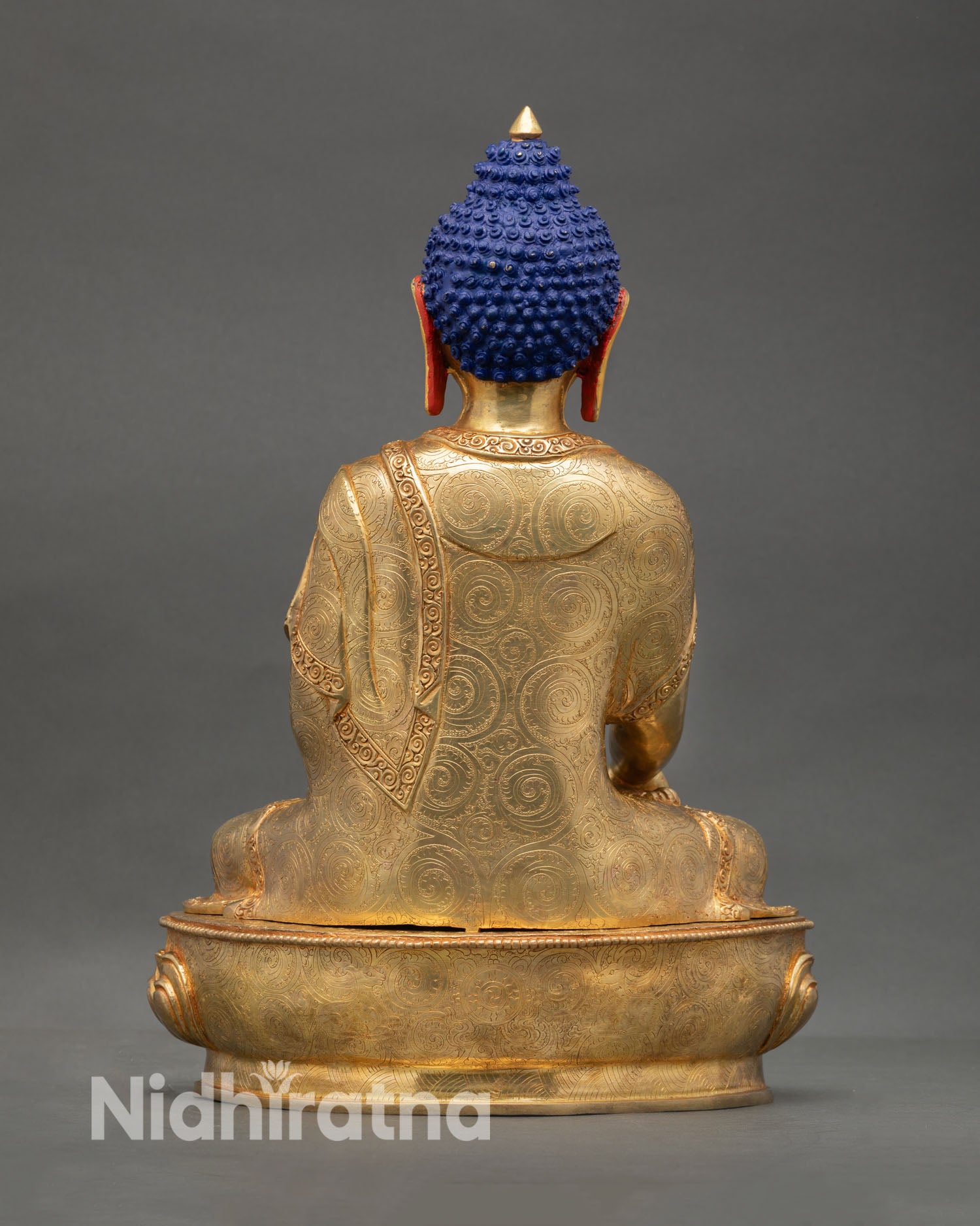 Back view Shakyamuni Buddha statue showing detailed robes lotus base sculpture for altar decor and sacred interior space