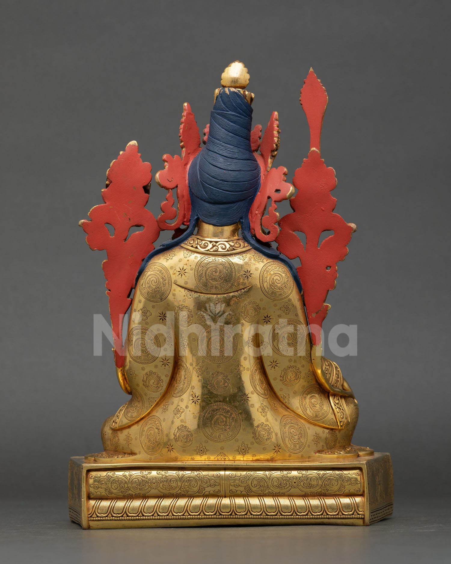Back view of Tibetan Dharma King statue with utpala flowers Prajnaparamita Sutra and wisdom sword for meditation and spiritual decor