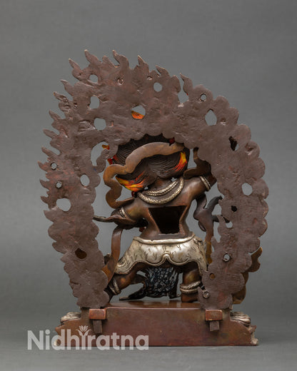 Back view of Vajrapani statue flame halo detail oxidized copper Buddhist protector decor