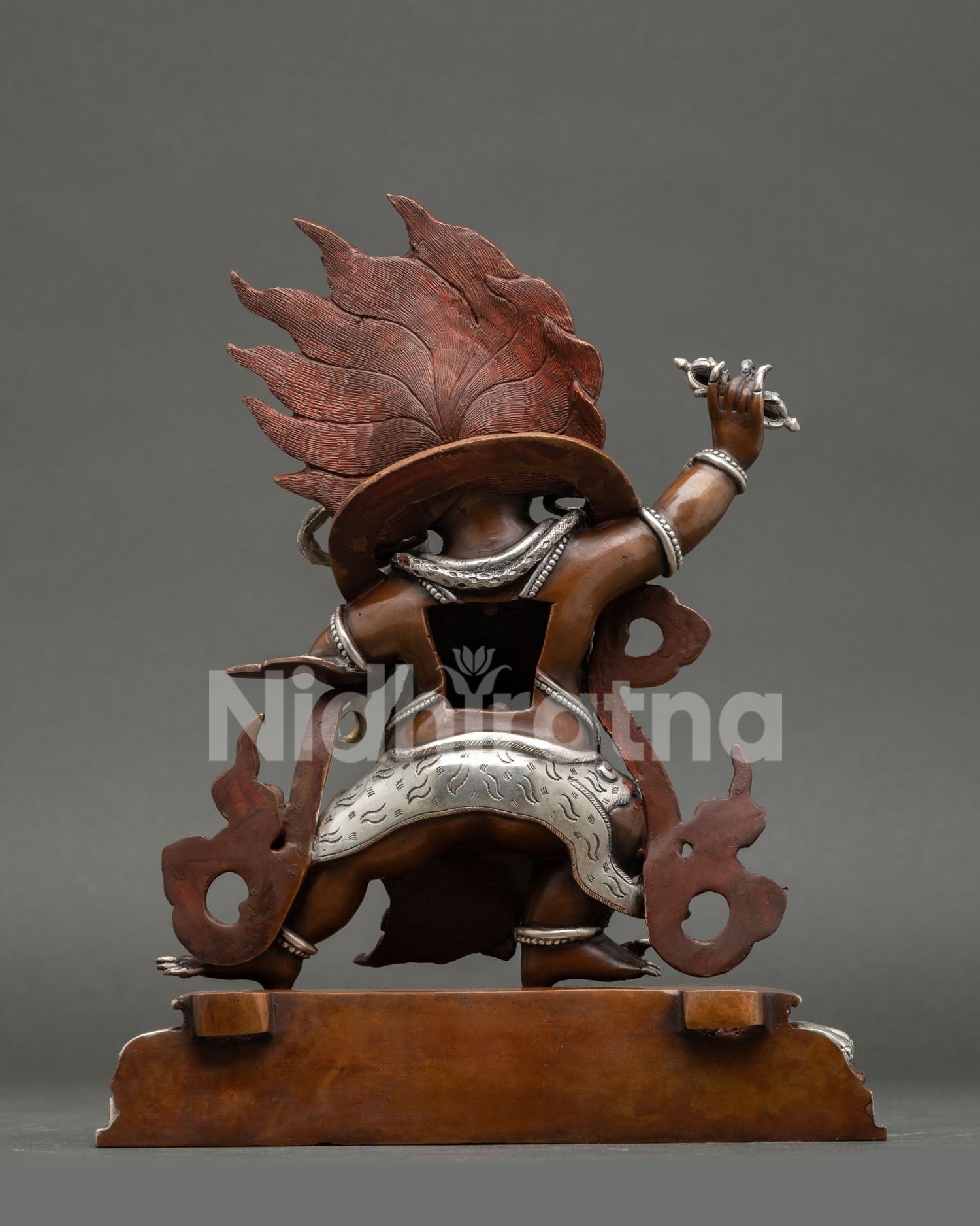 Back view of Vajrapani statue Himalayan Buddhist sculpture oxidized copper finish silver highlights spiritual protection deity