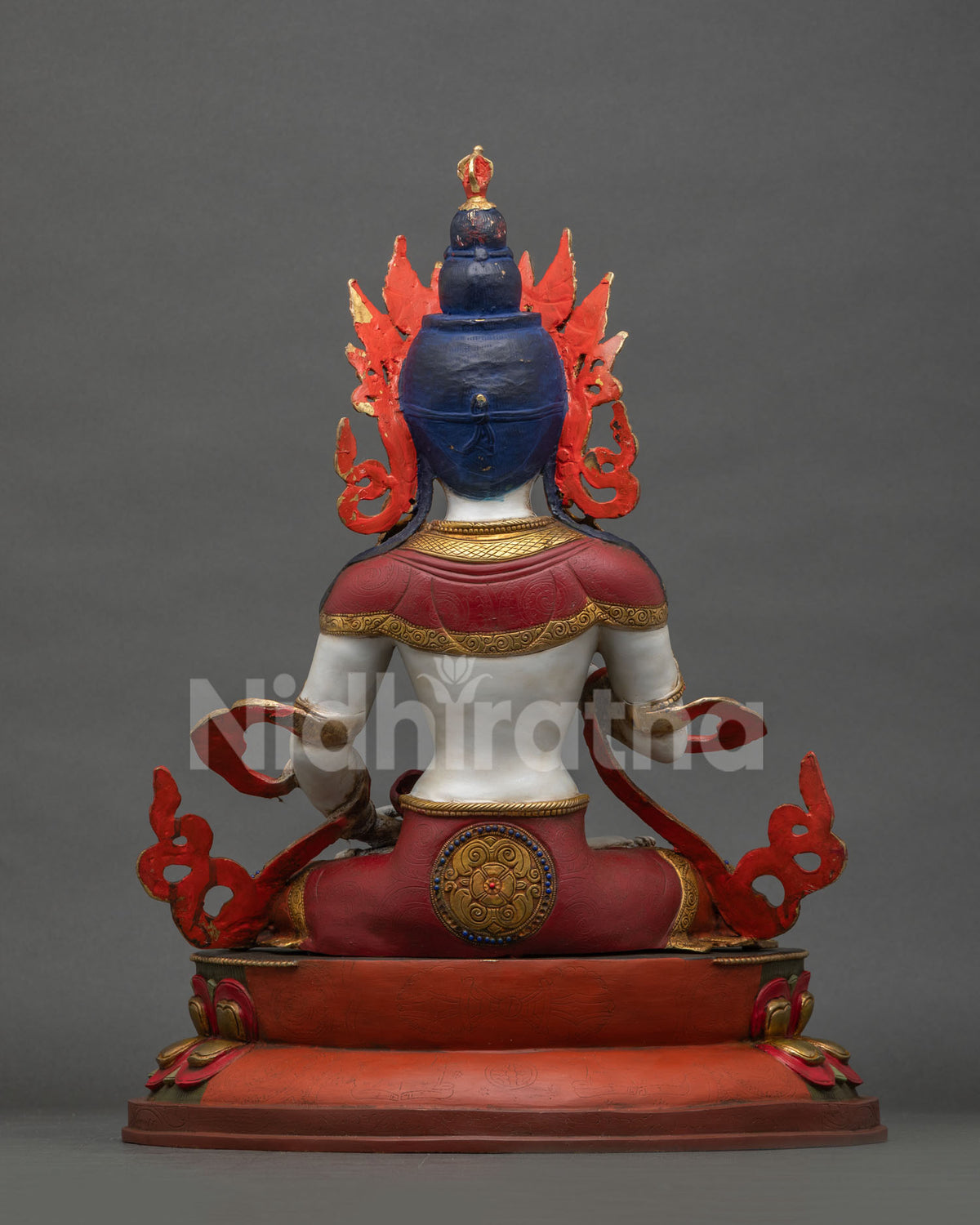 Back view of Vajrasattva statue showing blue hair, crown, and lotus base detail