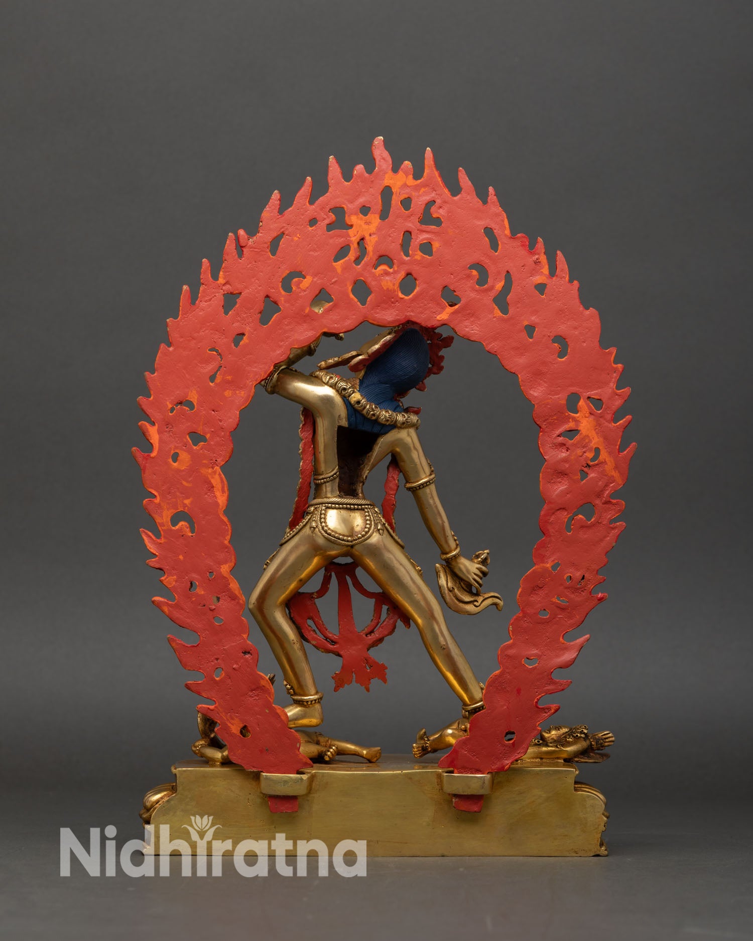 Back view Vajrayogini statue handcrafted Nepal copper sculpture lotus base two subdued figures sacred Tibetan Buddhist deity art.
