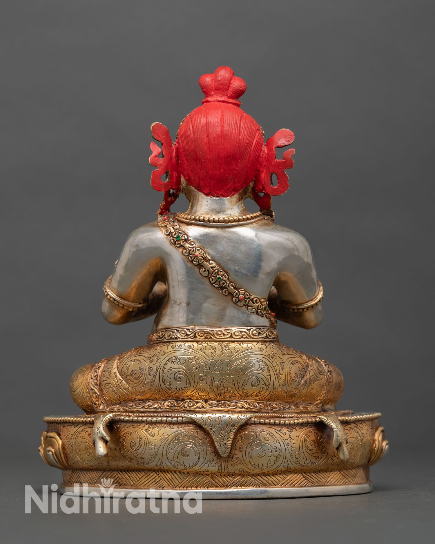 Back view of Virupa statue showing ornate carving silver plating and traditional Nepalese lost wax work