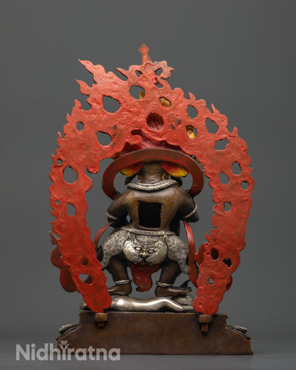 back view Sakya Mahakala statue highlighting silver-plated halo with carved deities and animals