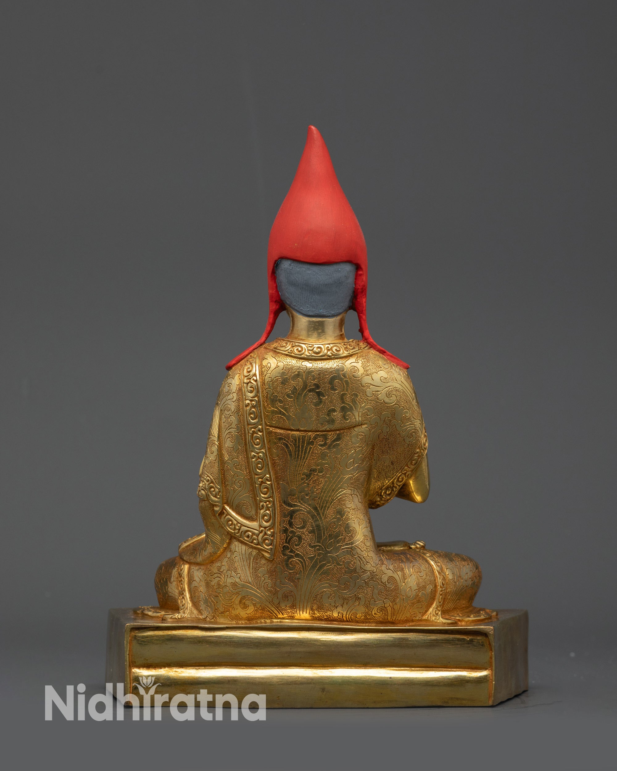 back view Trisong Detsen statue with crown flowing robes dharma wheel and utpala flowers