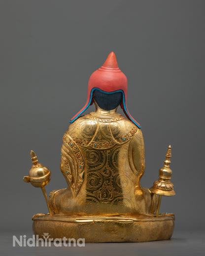 back view of Atisa statue highlighting detailed robe folds and fire-gilded copper craftsmanship