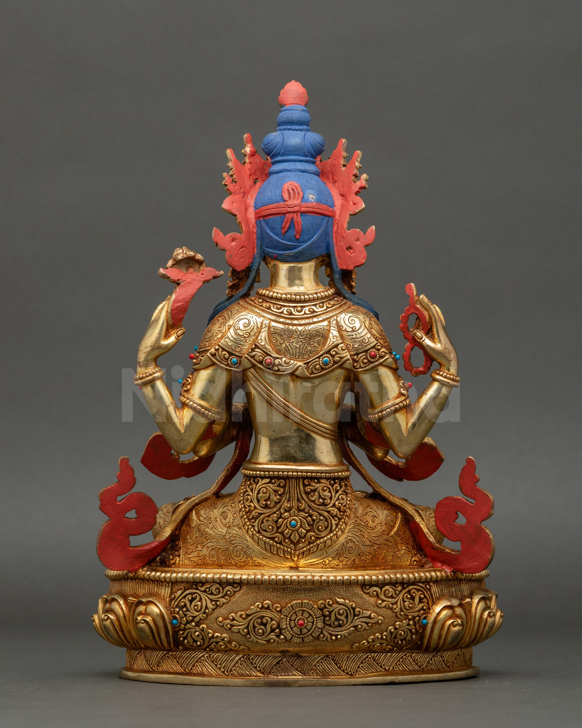 back view of Chenrezig statue showing gilded patterns and artisan carvings