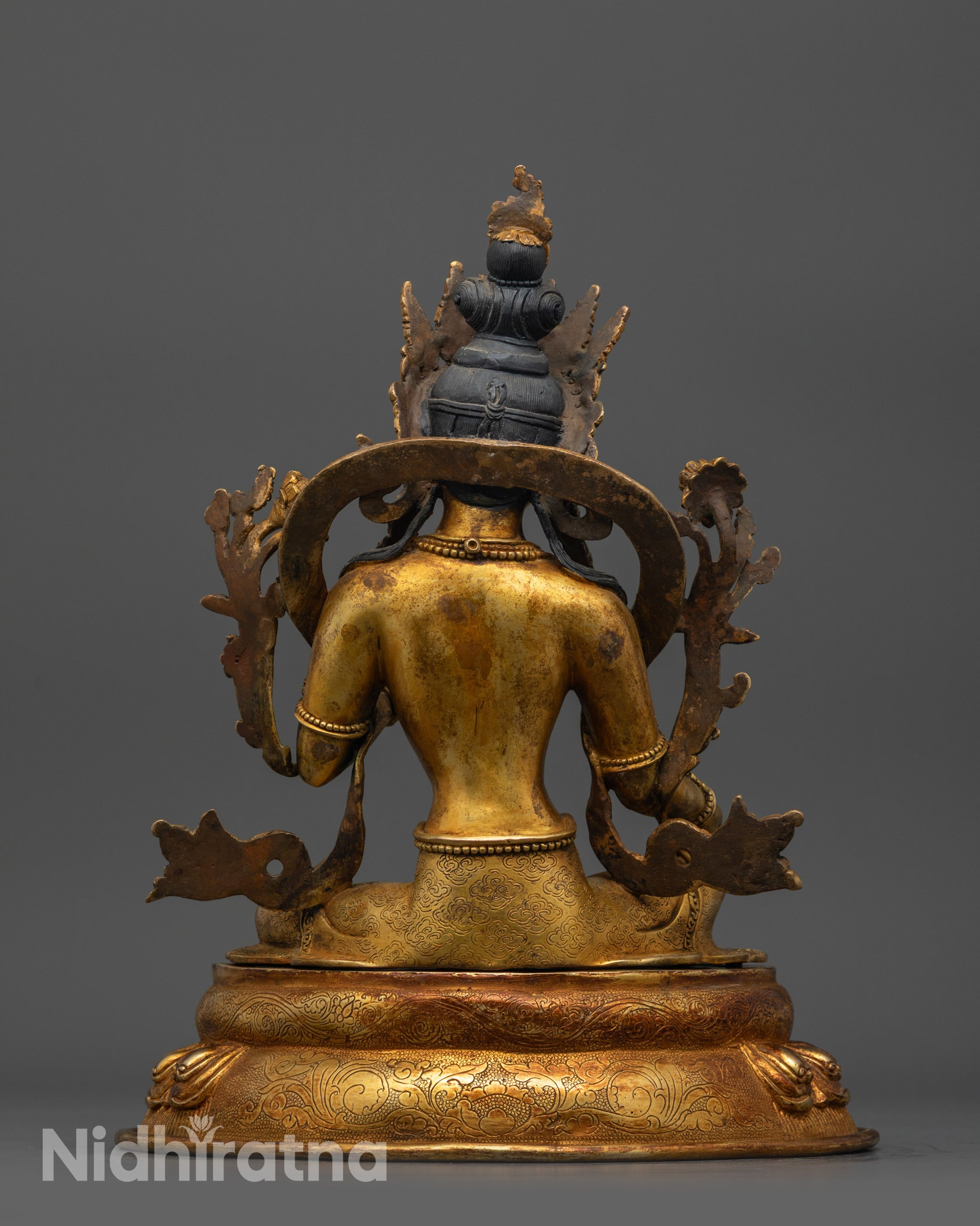 back view of Green Tara Statue highlighting detailed lotus seat and carved robe patterns