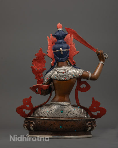 back view of Manjushri Statue displaying intricate carvings and antique silver-copper finish