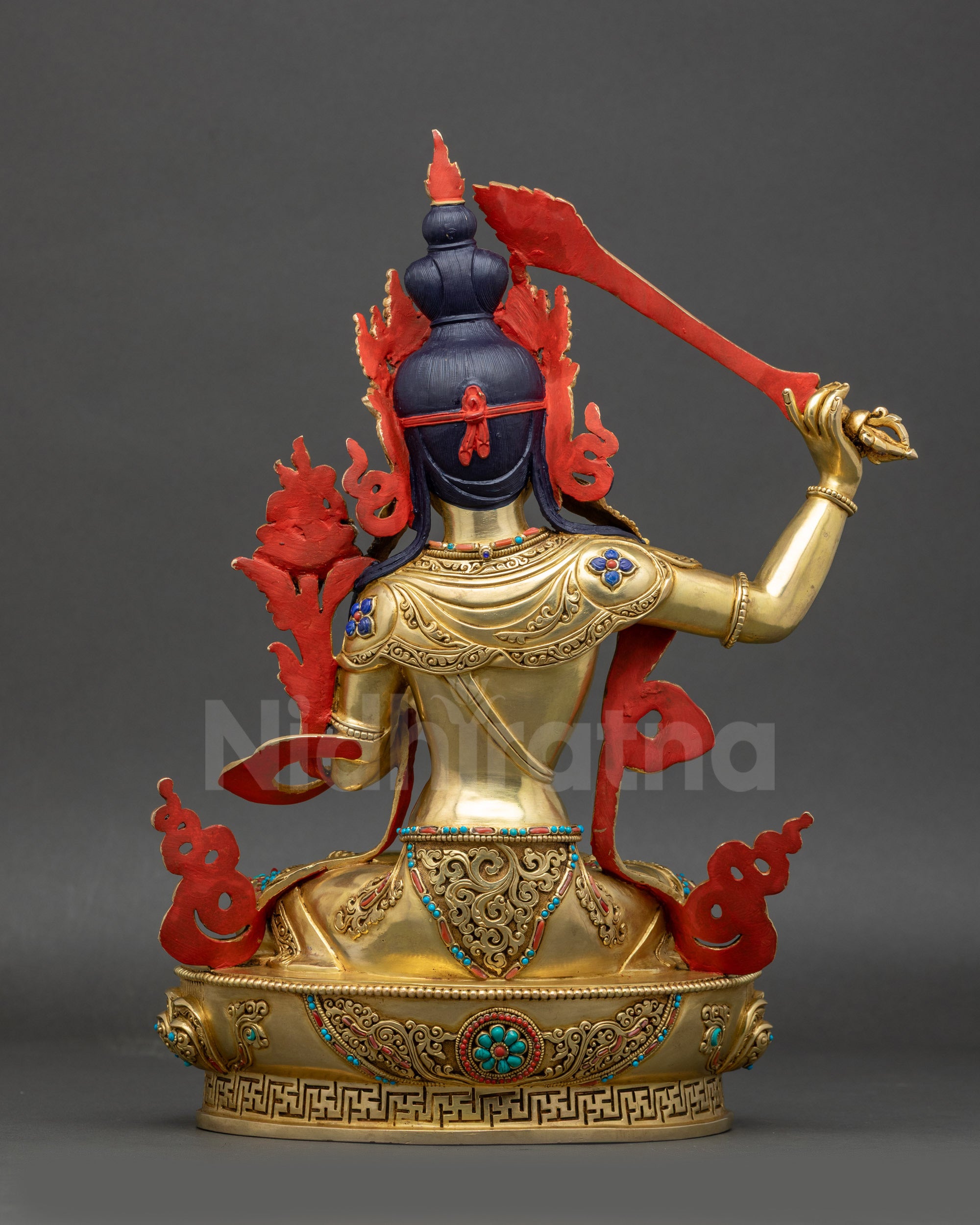 back view of Manjushri statue featuring detailed lotus pedestal carvings and robes