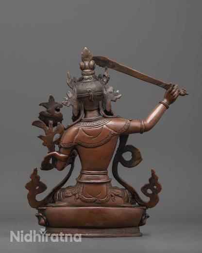 back view of Manjushri statue highlighting robe detail and hollow lotus base craftsmanship