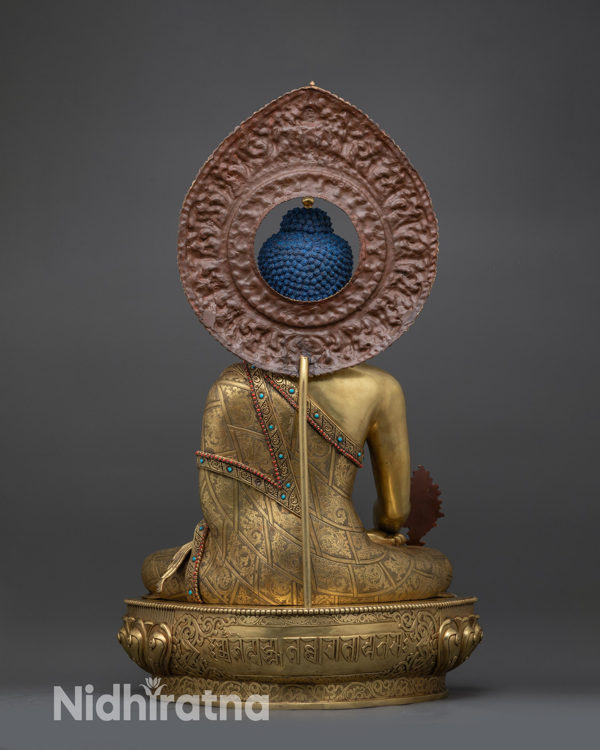 back view of Medicine Buddha Statue showing engraved Bhaisajyaguru mantra on lotus base