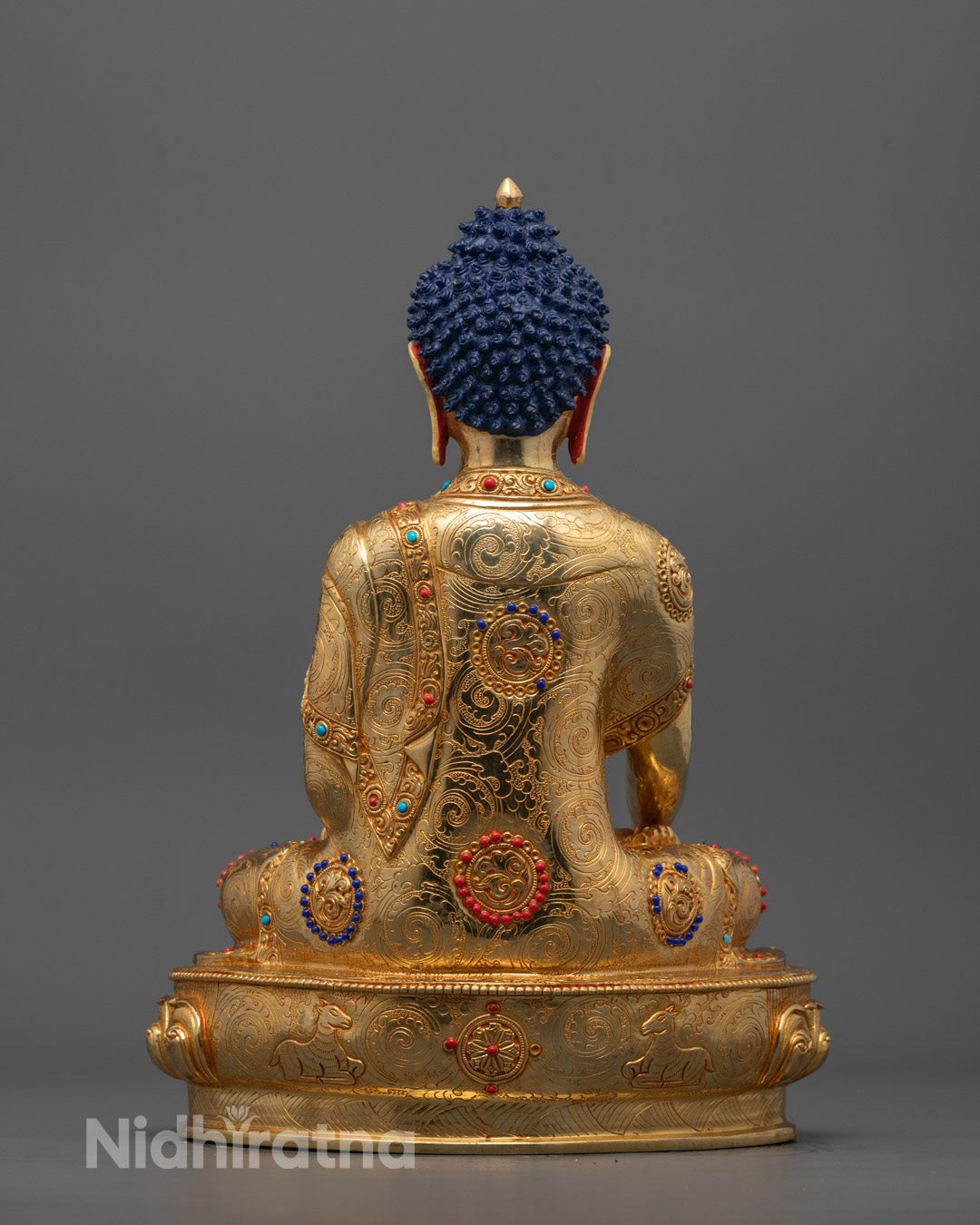 back view of Shakyamuni Buddha Statue highlighting intricate carvings and copper-gilded base









