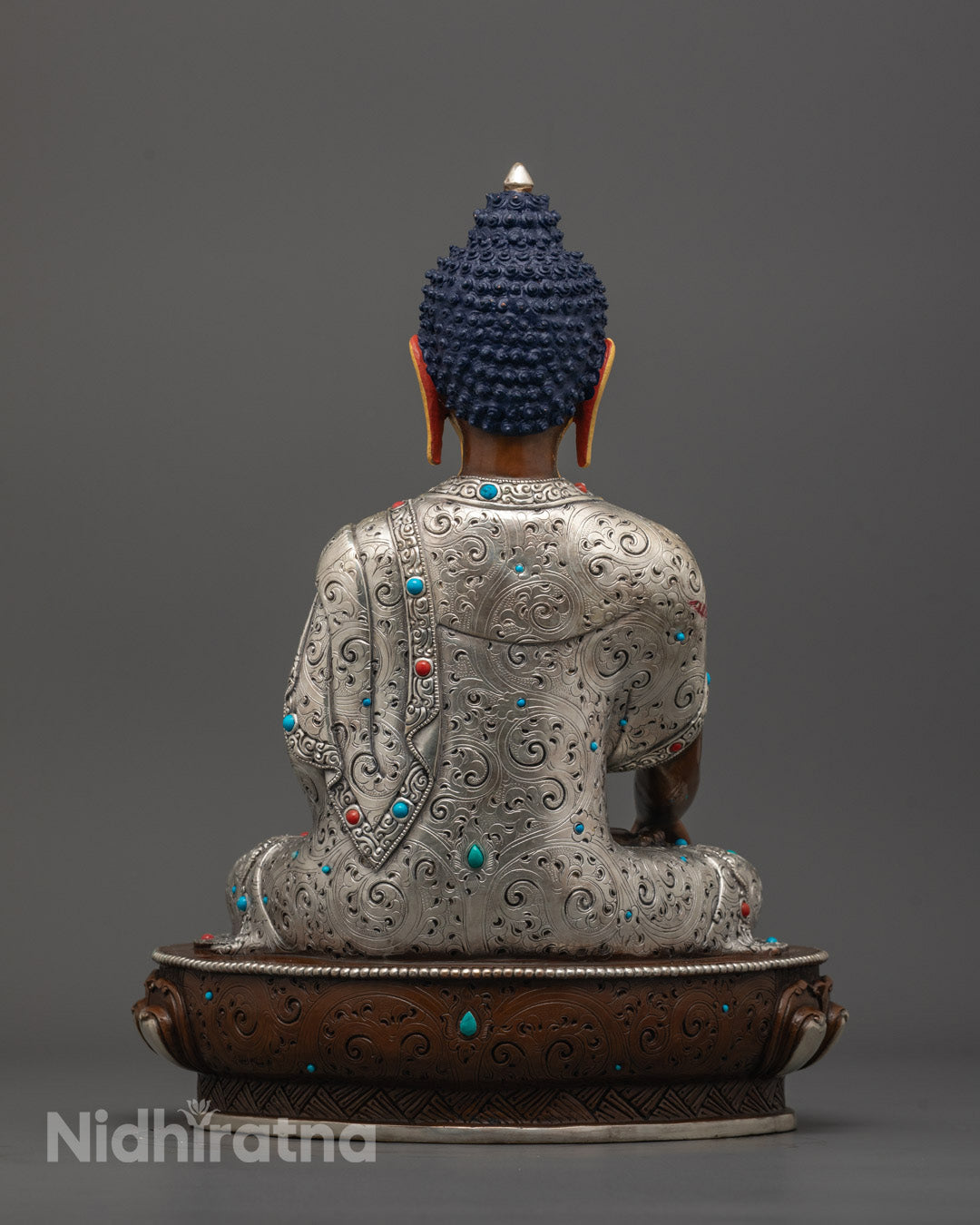 back view of Shakyamuni Buddha Statue highlighting oxidized copper body and ornate robe carving