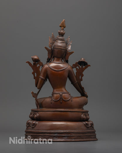 back view of dark oxidized green tara statue highlighting intricate lotus base detailing