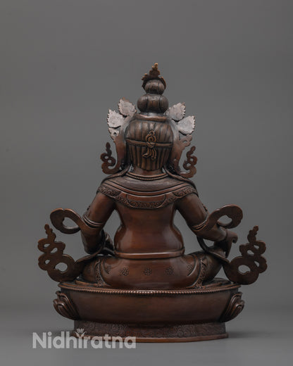back view of dzambhala wealth statue displaying robe details and dark oxidized copper texture