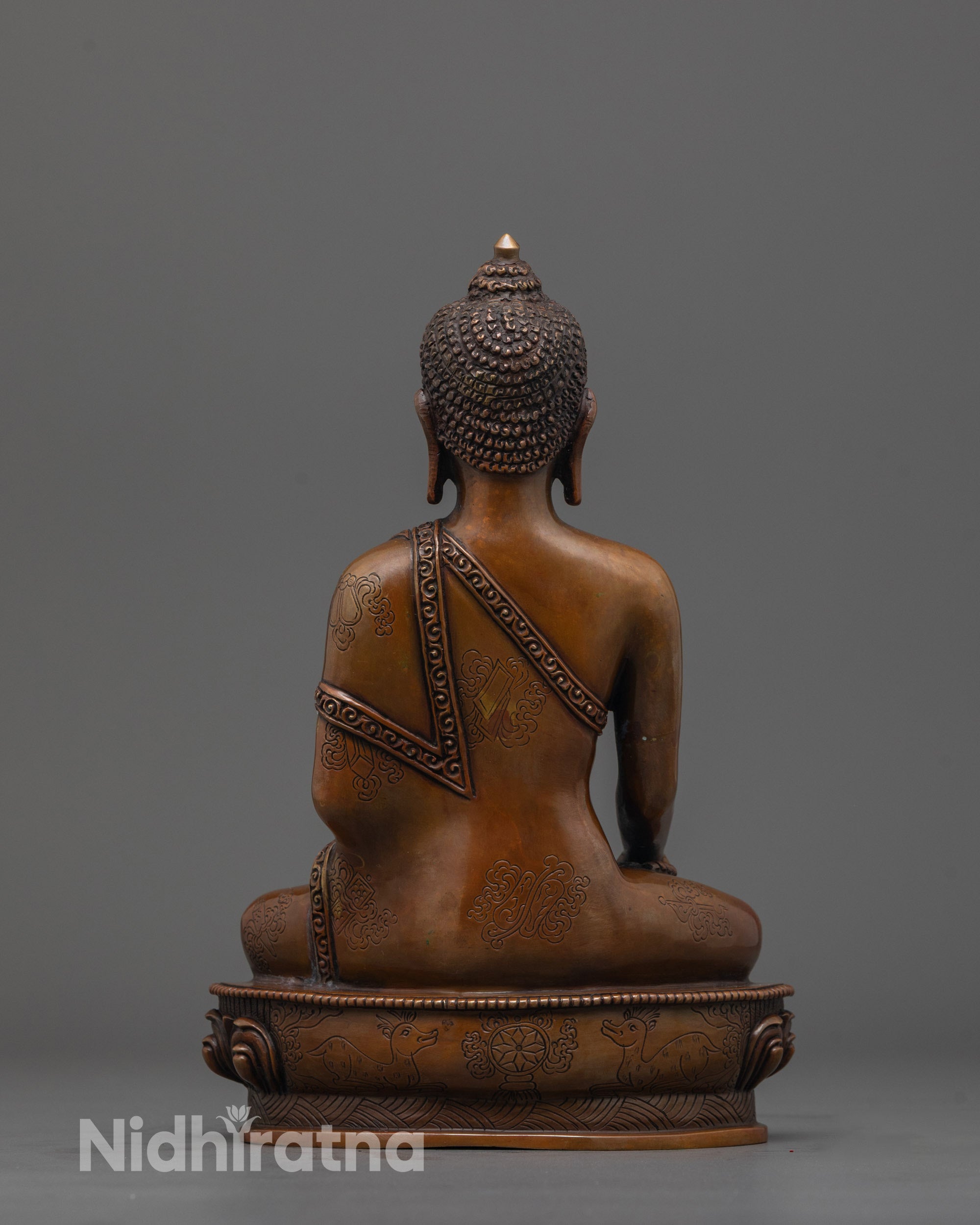 back view of handcrafted Buddha Statue with detailed robe and smooth oxidized copper texture