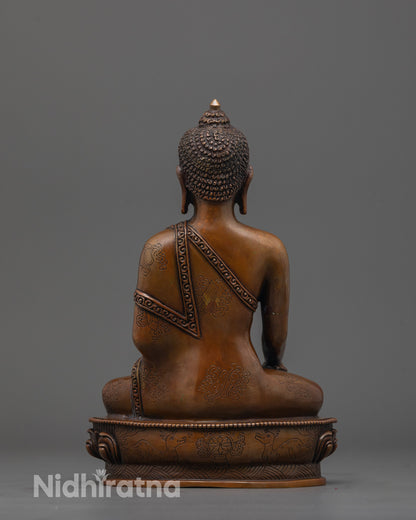 back view of handcrafted Buddha Statue with detailed robe and smooth oxidized copper texture