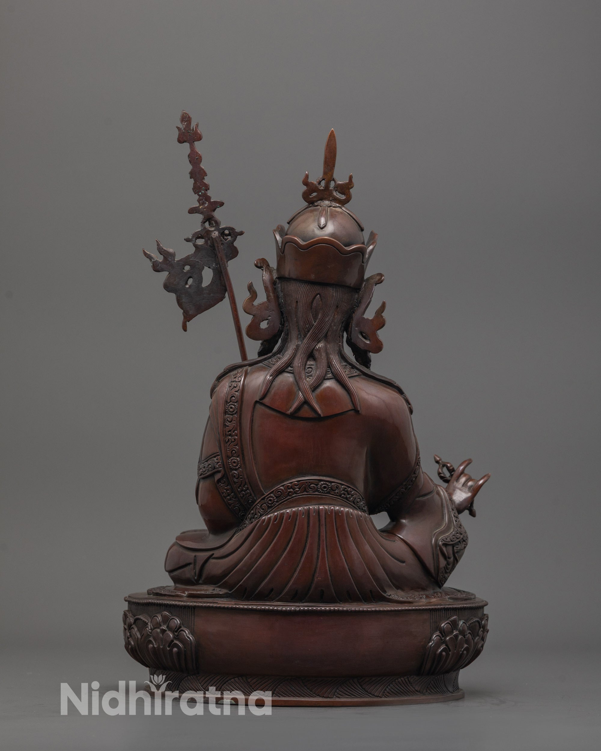 back view of handcrafted padmasambhava statue in oxidized copper with intricate carvings