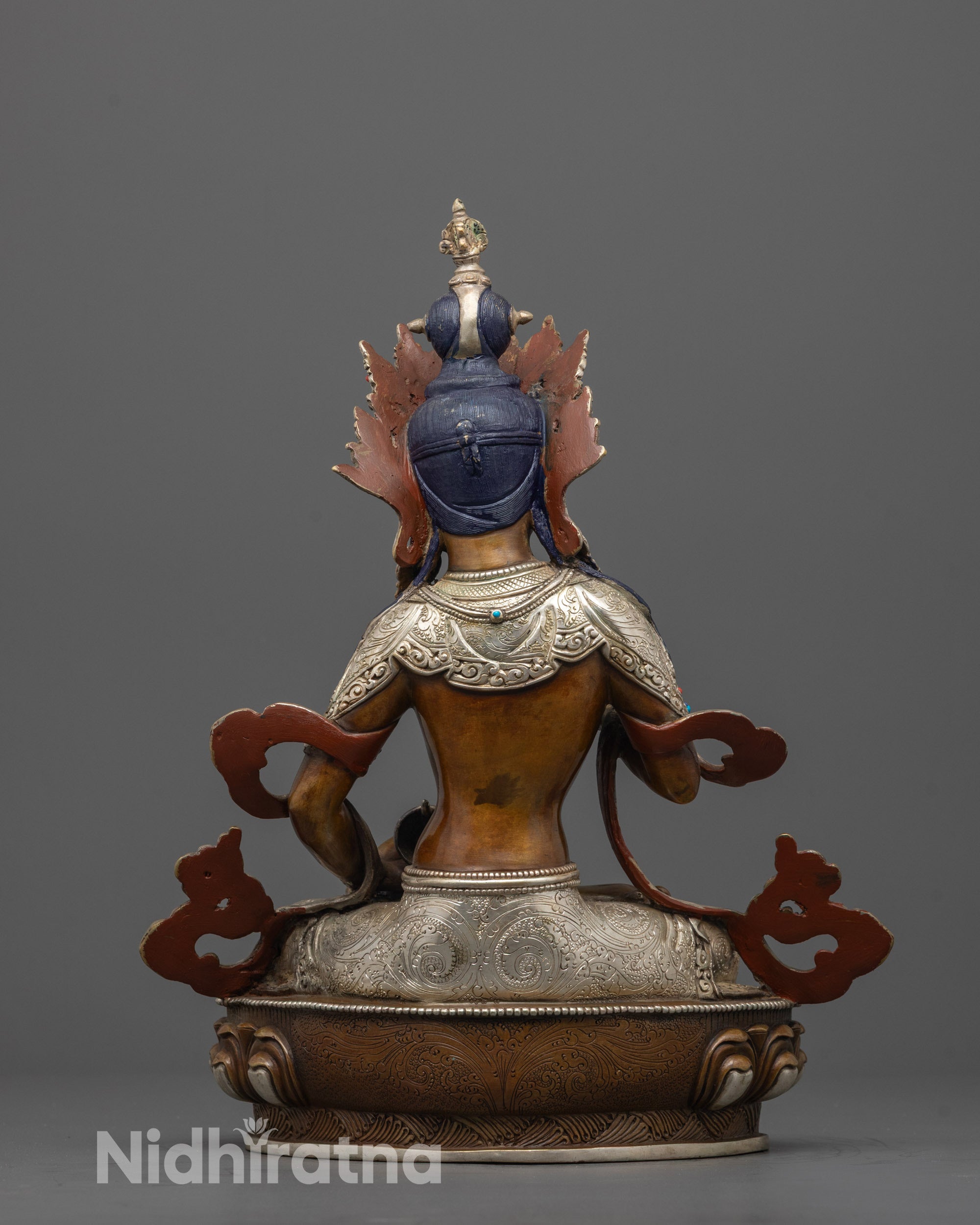 back view of handcrafted vajrasattva statue with silver body and oxidized copper base