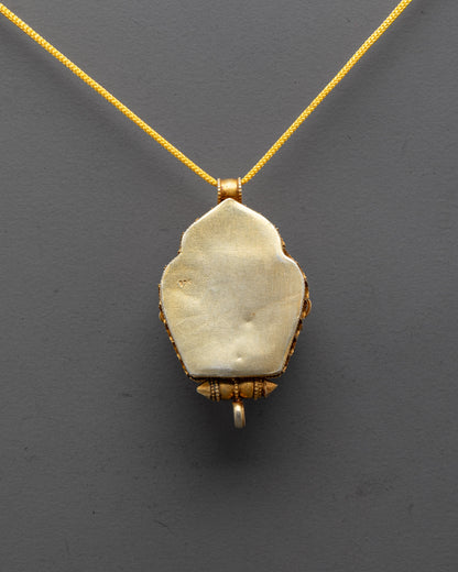 back view of intricate filigree design on gold-plated Dzambhala pendant from Patan Nepal