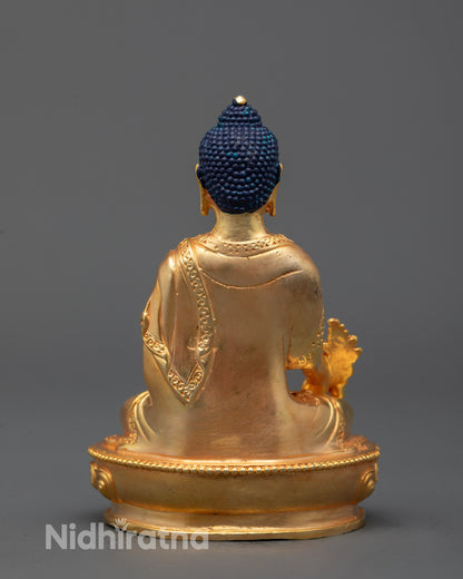 back view of machine-crafted medicine buddha statue with smooth gold-plated surface