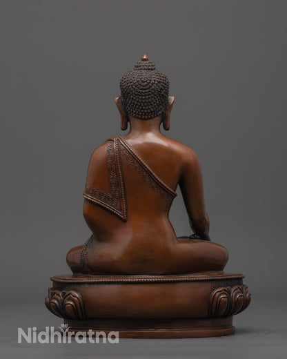 back view of oxidized Buddha statue highlighting intricate patterns on carved robe