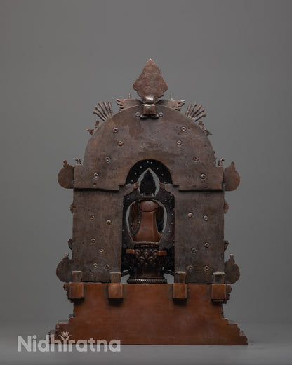 back view of oxidized buddhist sculpture showing throne base and detailed back halo design