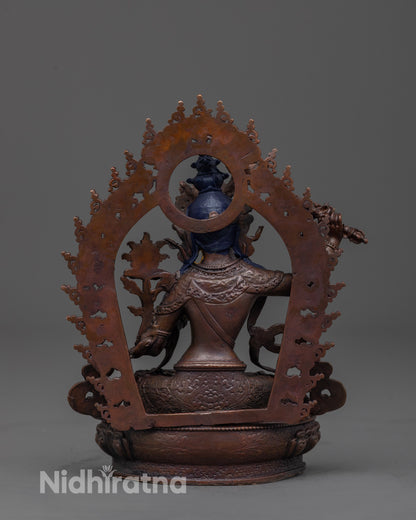 back view of oxidized copper manjushri statue with detailed robe and halo craftsmanship