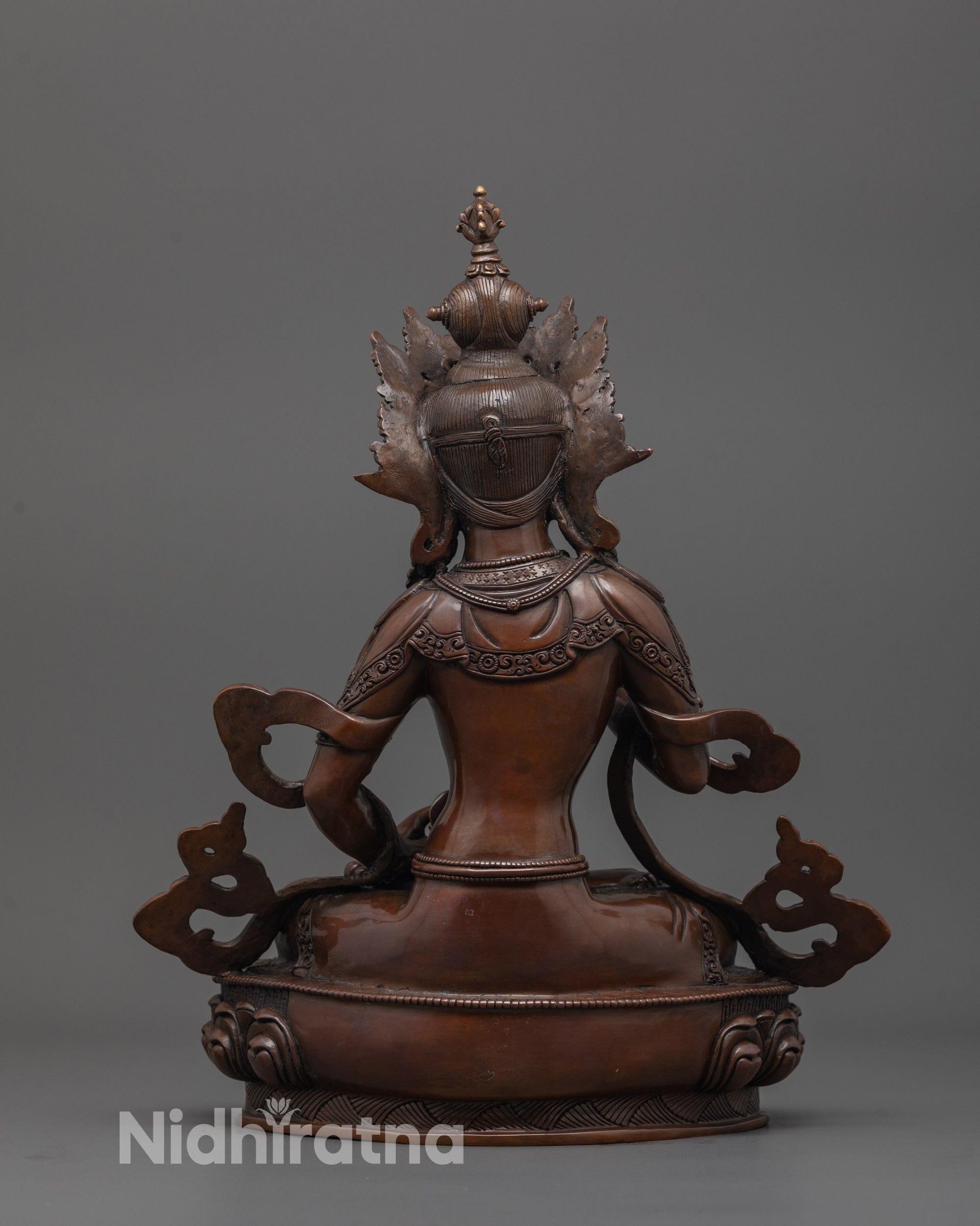 back view of oxidized dorje sempa statue showing detailed robe and copper finish