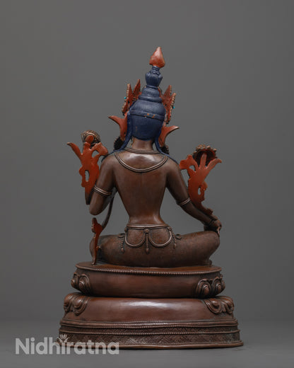 back view of oxidized green tara figurine with double-layered lotus seat and antique finish