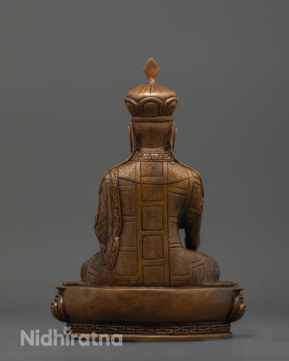 back view of oxidized karmapa statue displaying detailed carvings and crown pattern