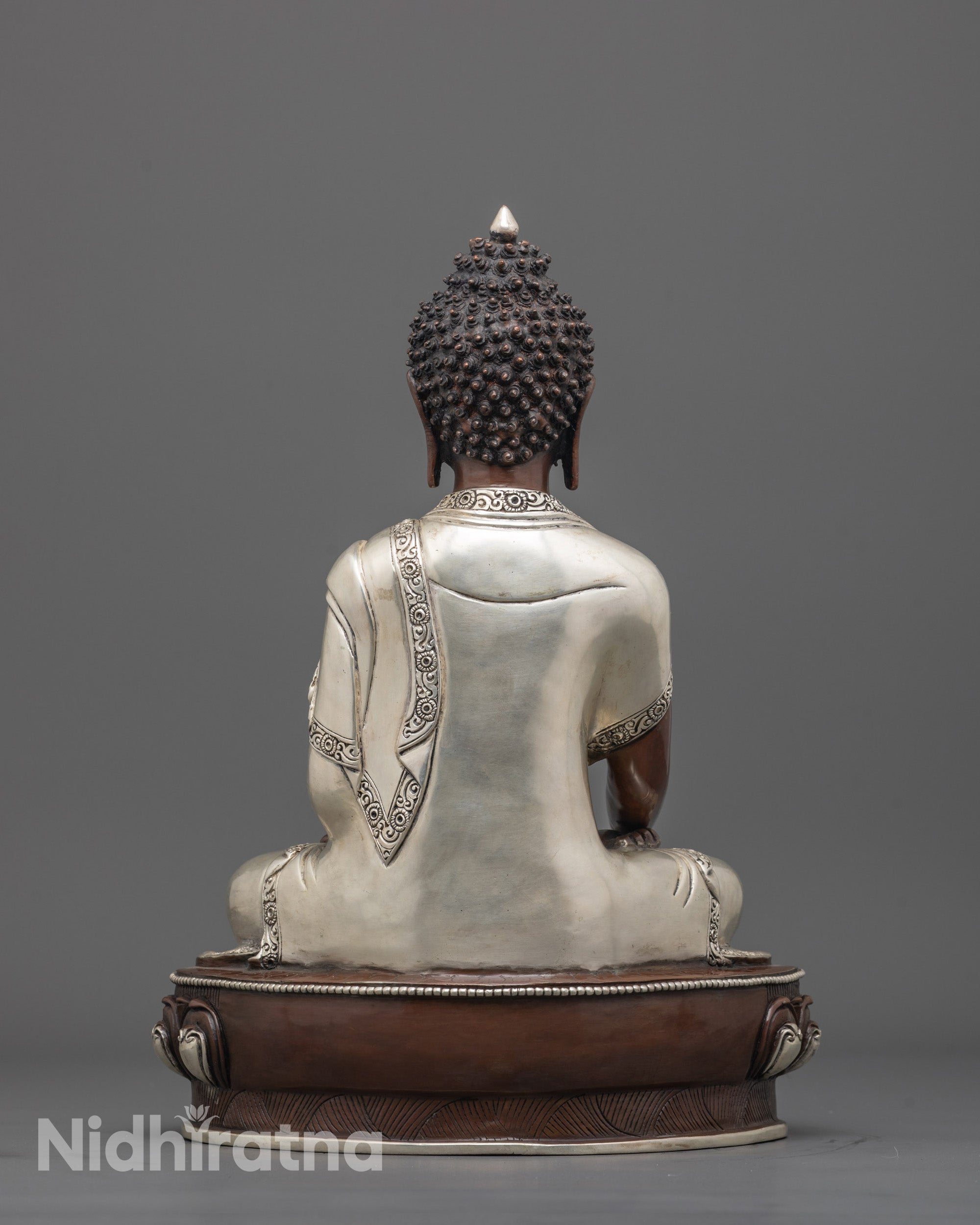 back view of silver-plated monk's robe on oxidized copper Nepalese Buddha sculpture