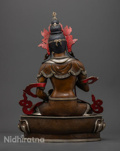 back view of vajrasattva statue showing silver-plated robe patterns and oxidized copper finish
