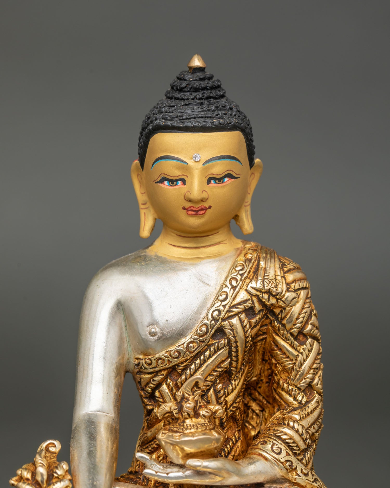 Bhaisajyaguru Buddha close up right hand Varada mudra holding myrobalan plant