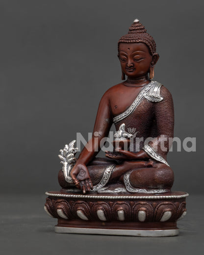 Bhaisajyaguru Medicine Buddha holding medicine bowl and myrobalan plant detail.