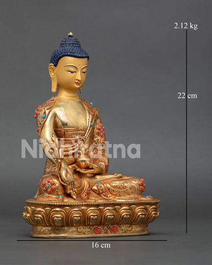 Bhaisajyaguru Medicine Buddha sculpture with gold painted face holding healing nectar bowl and Myrobalan plant