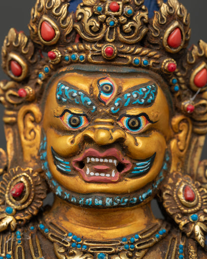 Black Dzambhala face close up with 24K gold-painted details and serene Buddhist expression