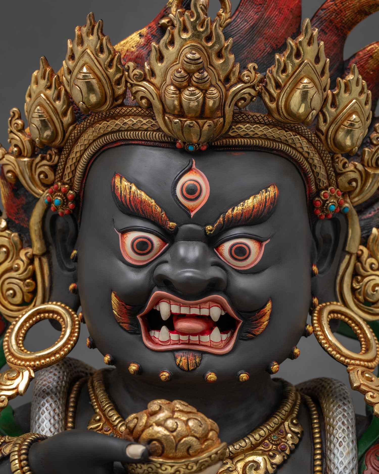 Black Dzambhala face close-up – wrathful expression, third eye detail