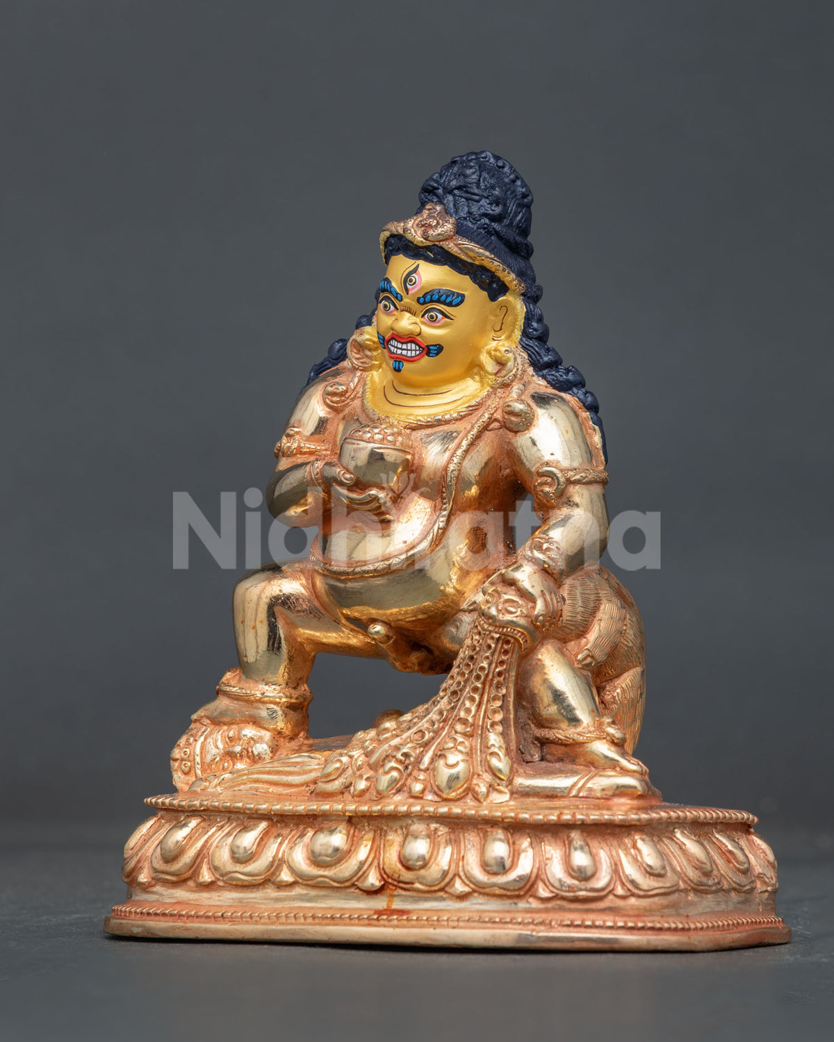 Black dzambhala holding skull cup and jewel spitting mongoose symbolizing wealth and abundance.