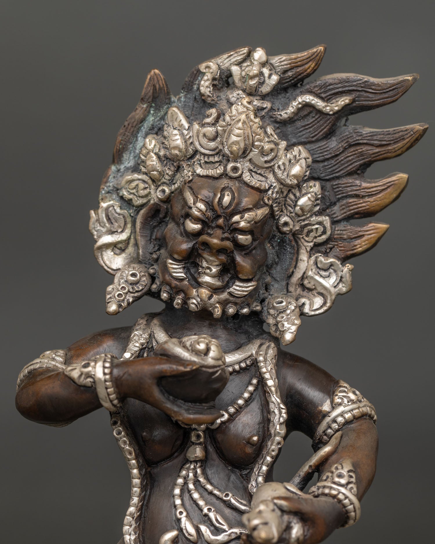 Black Dzambhala Statue close-up, flaming halo lotus pedestal, oxidized copper, handmade Nepal