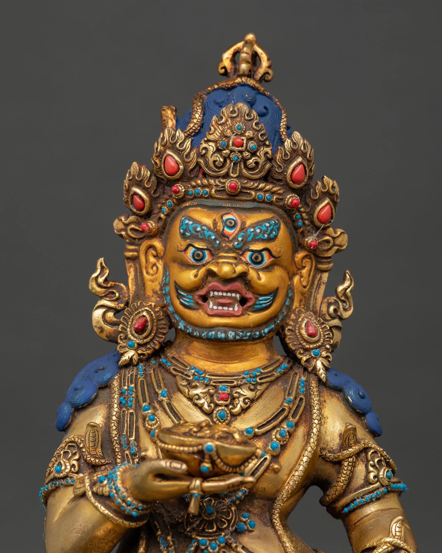 Black Dzambhala Statue close up showing gold gilding, antique finish, and intricate details