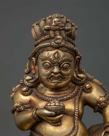 Black Dzambhala statue close up showing three fierce eyes and intricate Newari craftsmanship.