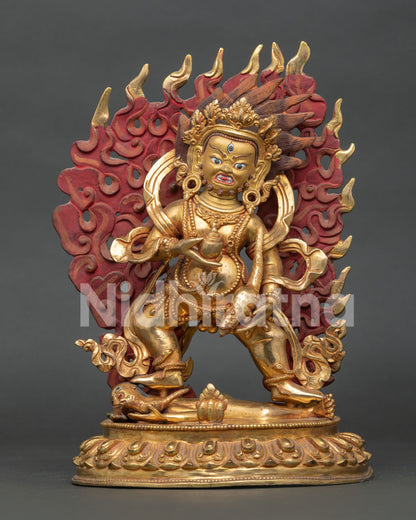 Black Dzambhala statue from Nepal with gold gilded copper body and powerful wrathful expression