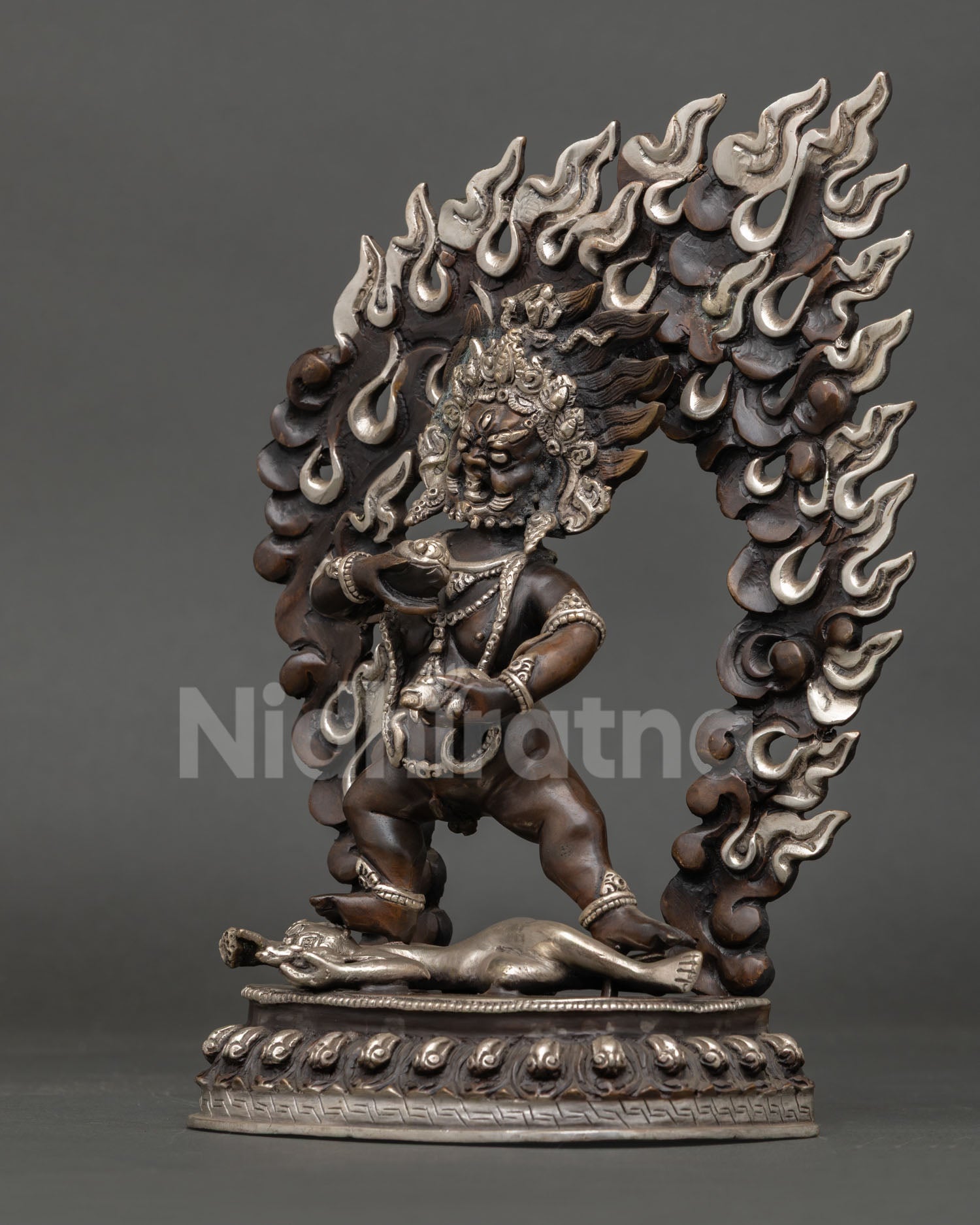 Black Dzambhala Statue left side view, lotus pedestal detail, oxidized copper, Tibetan deity Nepal