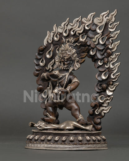 Black Dzambhala Statue left side view, lotus pedestal detail, oxidized copper, Tibetan deity Nepal