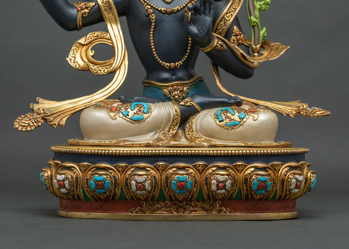 Black Manjushri statue seated in lotus posture on gold gilded throne inlaid with turquoise and coral