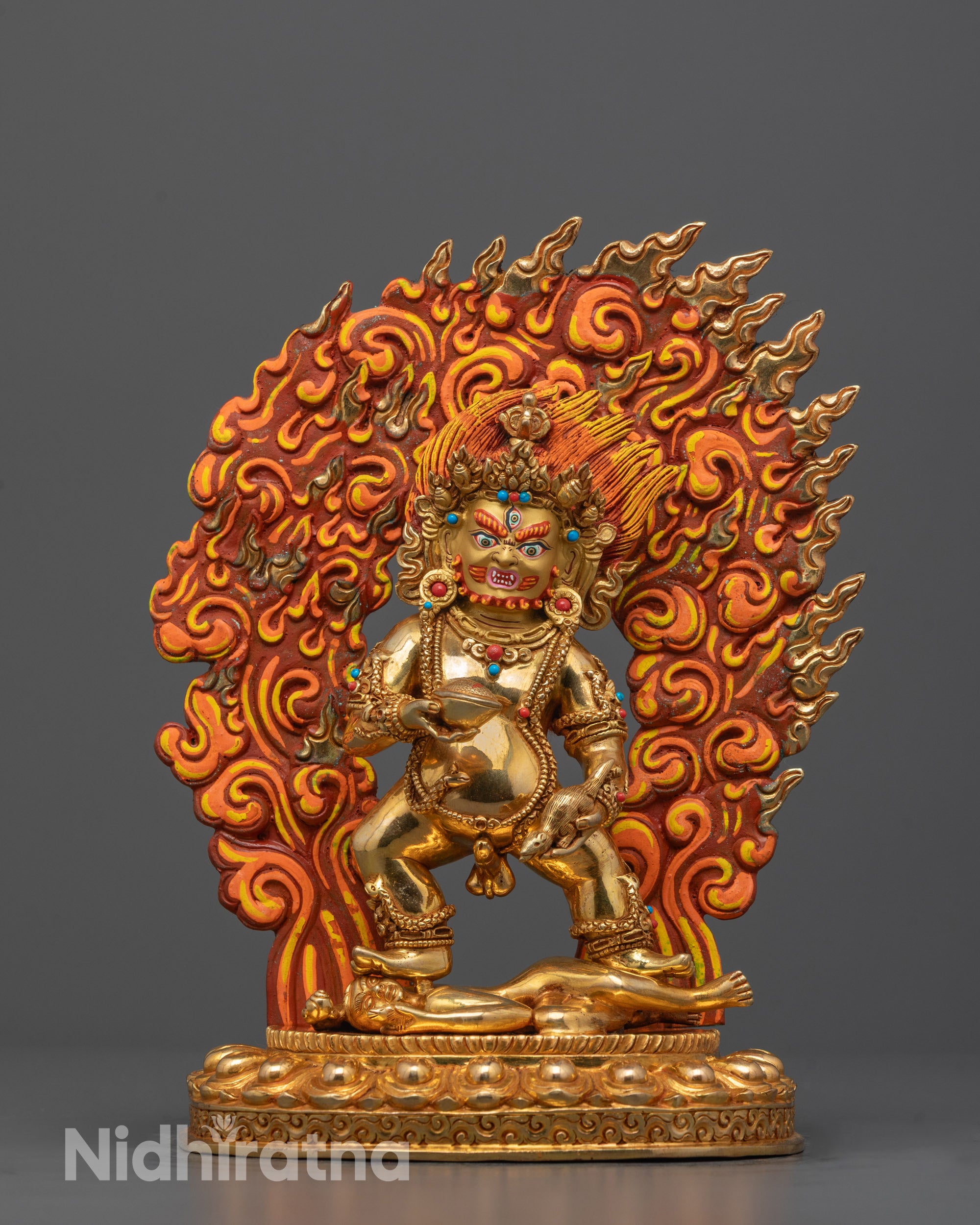 black dzambhala statue front view with gold gilded face and wrathful stance for protection