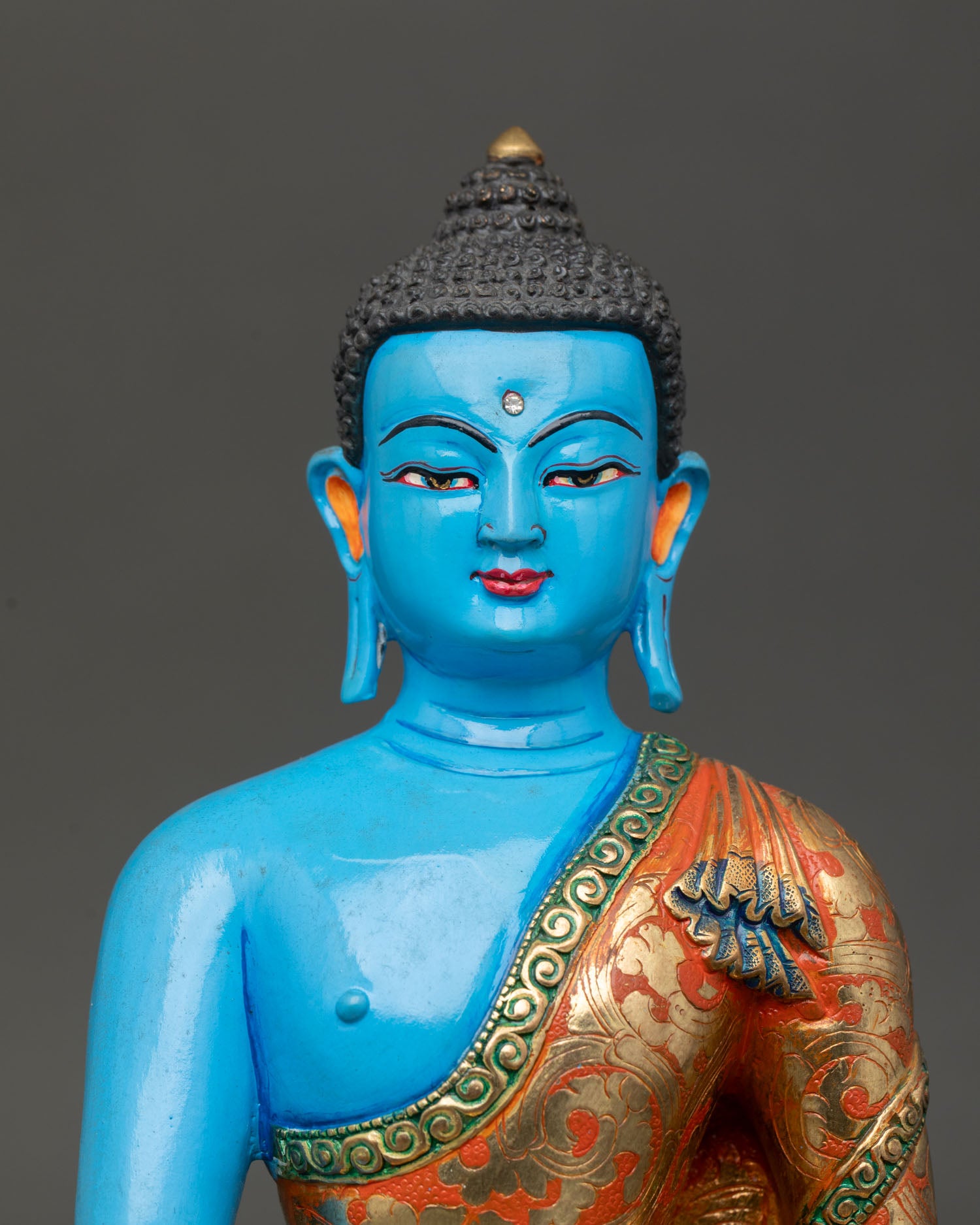 blue shakyamuni buddha statue close up, acrylic painted buddhist sculpture from nepal